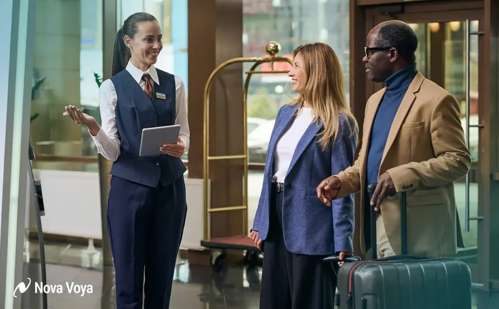 Hospital concierge staff assisting an international patient and their family with luggage, demonstrating patient-centric support services.