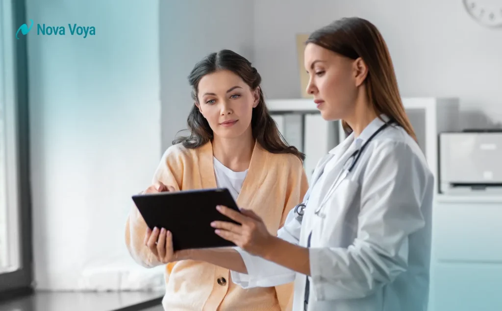 Healthcare provider sitting and engaging empathetically with a patient, demonstrating effective bedside manner and communication.