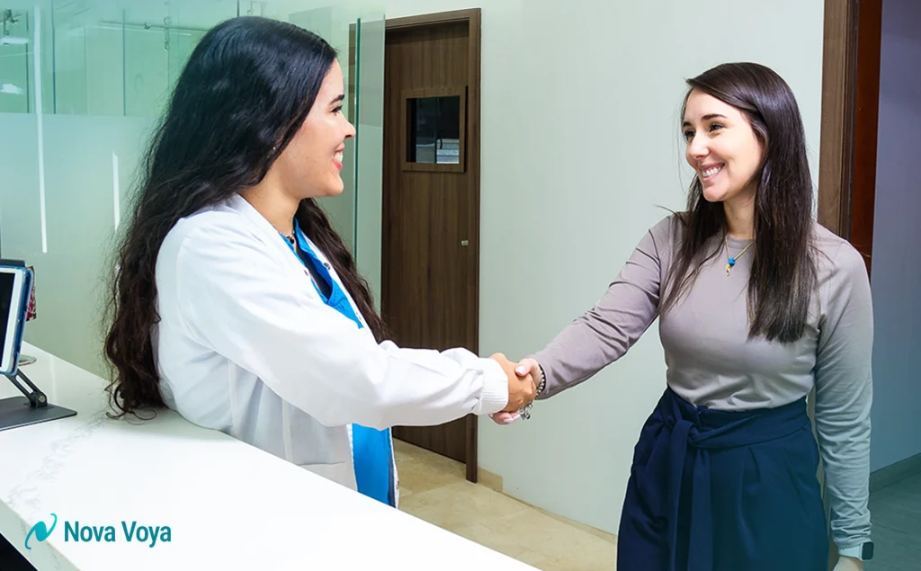 A doctor and an international patient smiling during a consultation