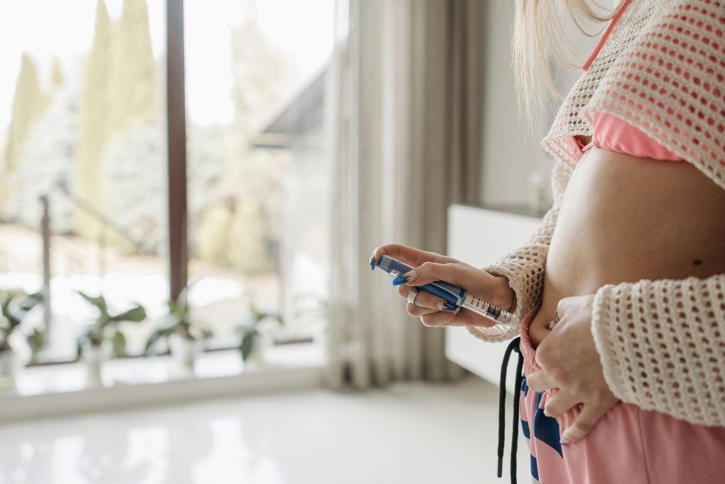 A Woman Using an Semaglutide or Tirzepatide Injection Pen